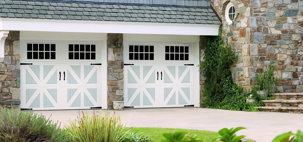 Amarr Classica Santiago garage door in true white with gray trim on a residential home
