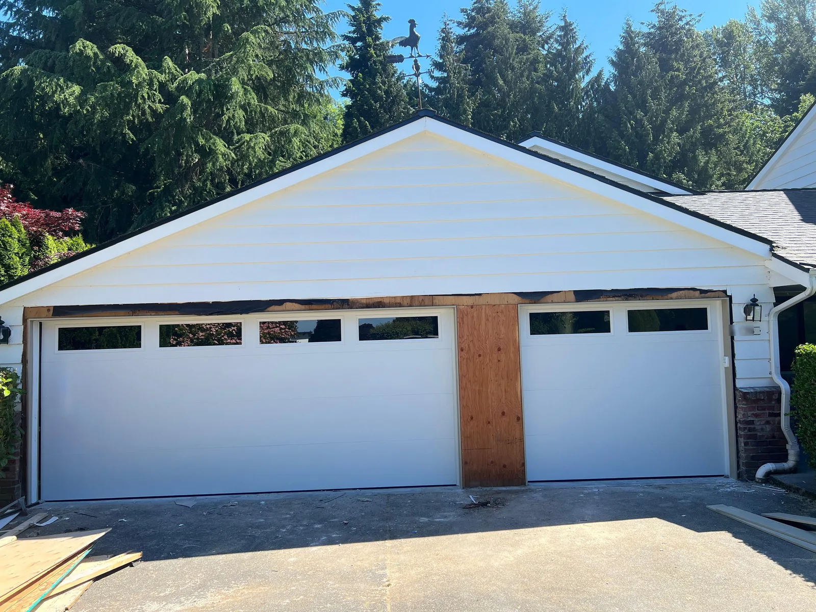 White flush garage doors with window row, newly installed on a Bellevue home